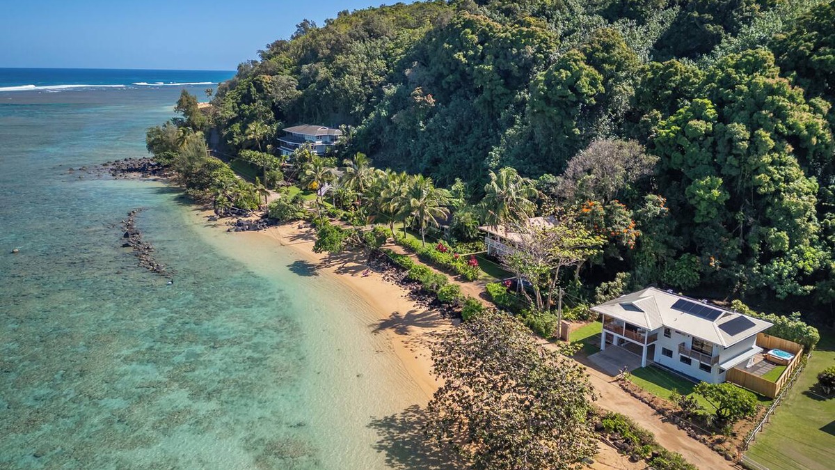 Kilauea House | Newly renovated beachfront retreat on Anini Beach offering direct ocean access, refined island living, and spectacular sunset views.