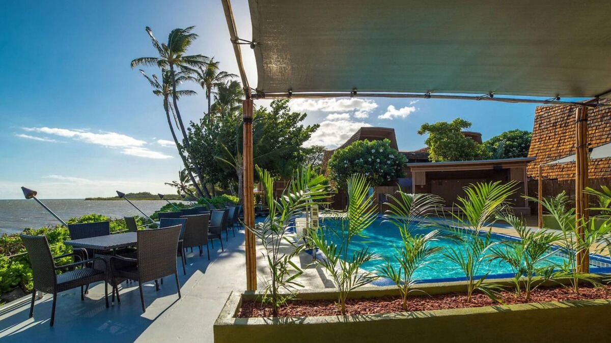 Kaunakakai House | Your Ultimate Oceanfront Retreat | Relaxing Room with Lush Garden View