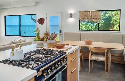 Kilauea House | Newly renovated beachfront retreat on Anini Beach offering direct ocean access, refined island living, and spectacular sunset views.