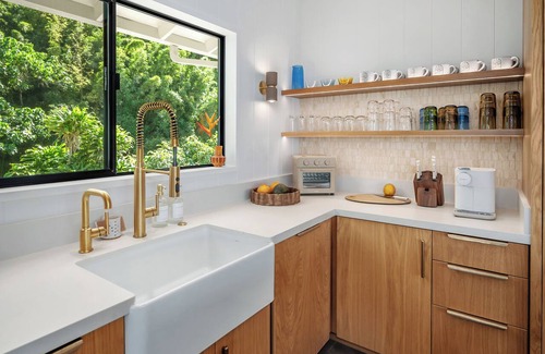 Kilauea House | Newly renovated beachfront retreat on Anini Beach offering direct ocean access, refined island living, and spectacular sunset views.