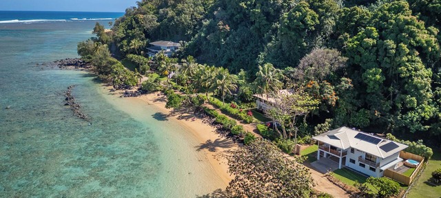 Newly renovated beachfront retreat on Anini Beach offering direct ocean access, refined island living, and spectacular sunset views.