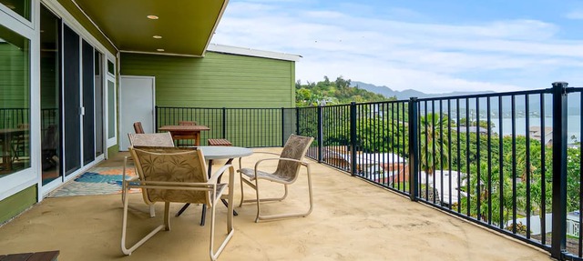 Two-story ocean view home with a furnished patio & deck, washer/dryer, & AC